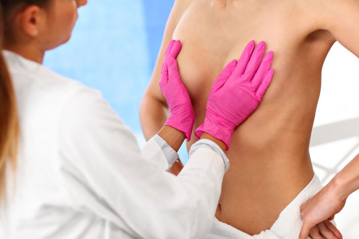 doctor examining breast hands on